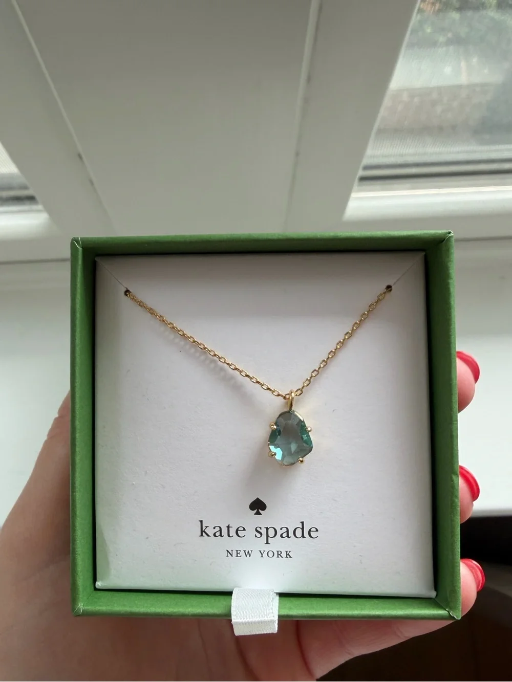 kate spade gold necklace with light blue stone pendant